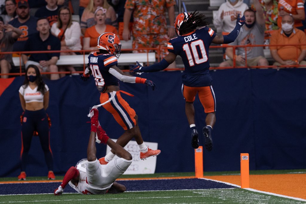 Syracuse’s Adrian Cole (10) and Rob Hanna (19) go airborne after teaming up to force an incompletion against Rutgers during an NCAA football game, Saturday, at the Carrier Dome.