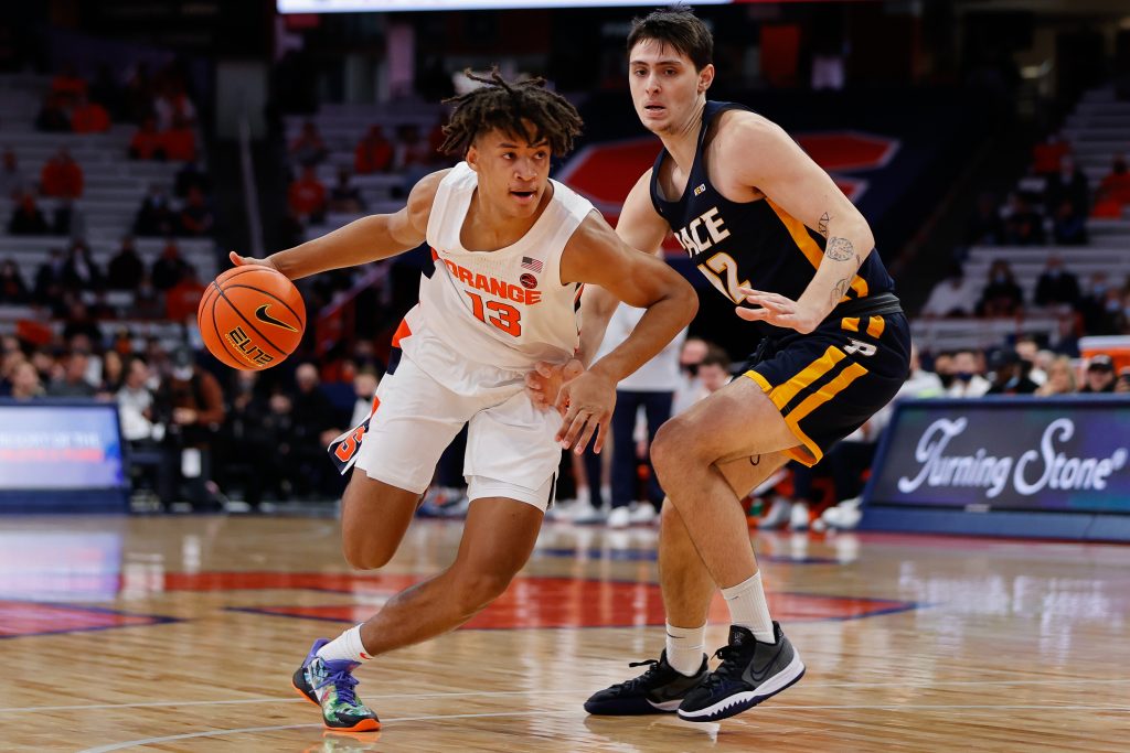 Syracuse's Benny Williams makes a drive past Pace University's Marc Dadika during a Men's Basketball exhibition game against Pace University on October 27, 2021.