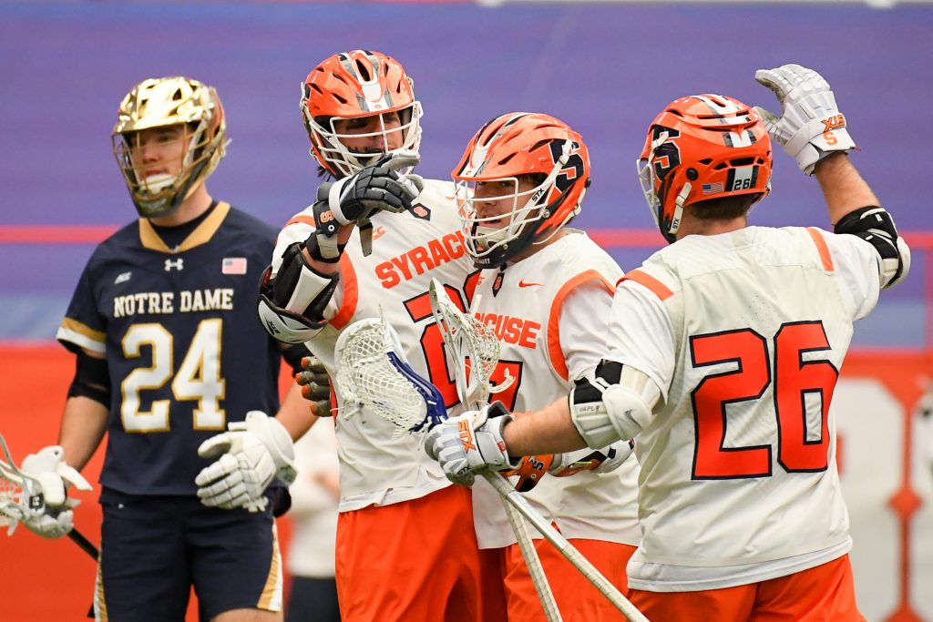 Syracuse Orange attackman Stephen Rehfuss (29) celebrates his goal with teammates against the Notre Dame Fighting Irish during the first half at the Carrier Dome.