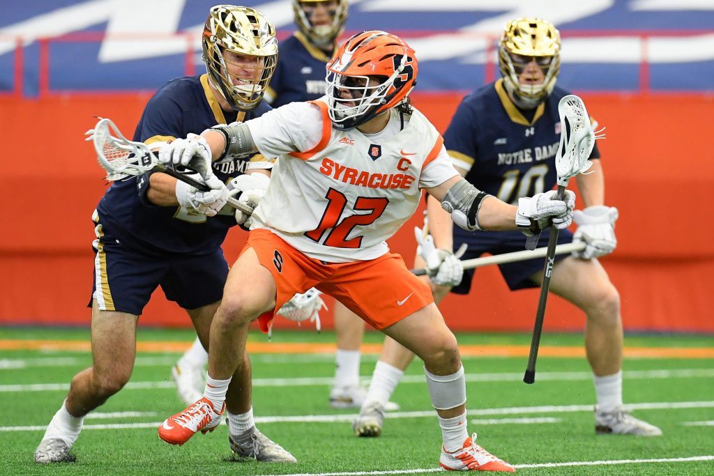 Syracuse Orange midfielder Jamie Trimboli (12) dodges to the goal against the Notre Dame Fighting Irish during the first half at the Carrier Dome.
