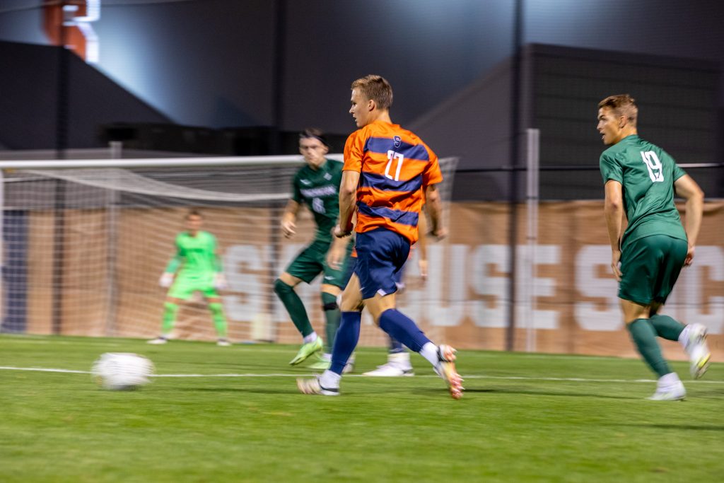 Syracuse Men's Soccer player Aidan Arber lays the ball inside during their 7-0 win versus Binghamton on September 14th, 2021.
