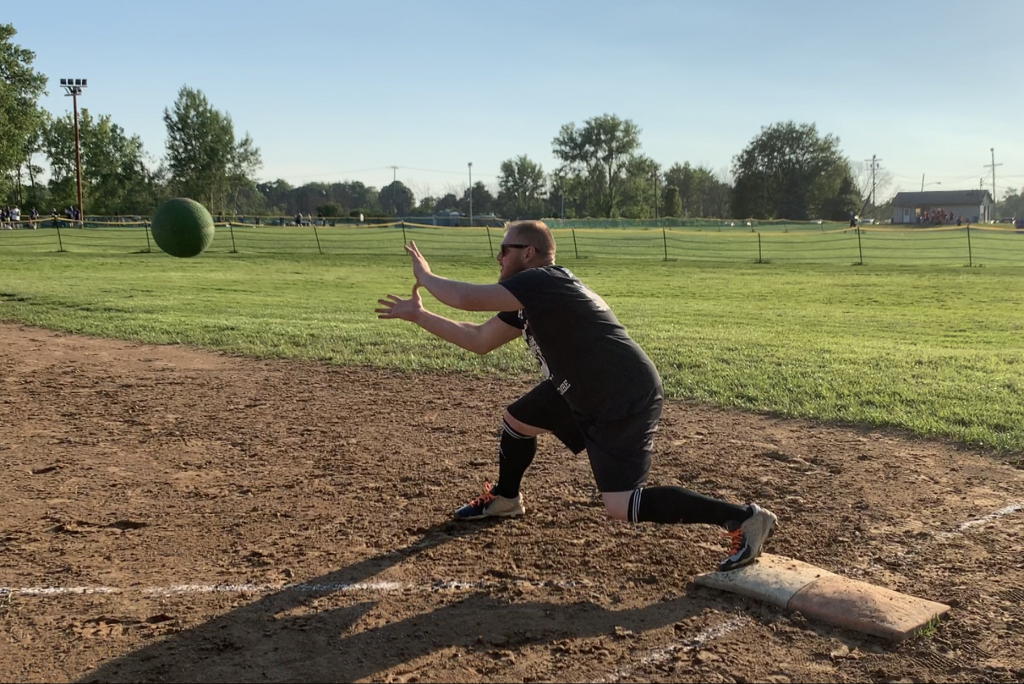 Dave Mara of BLYFLT stretches for a catch at first base to warm up before a matchup with another undefeated team.