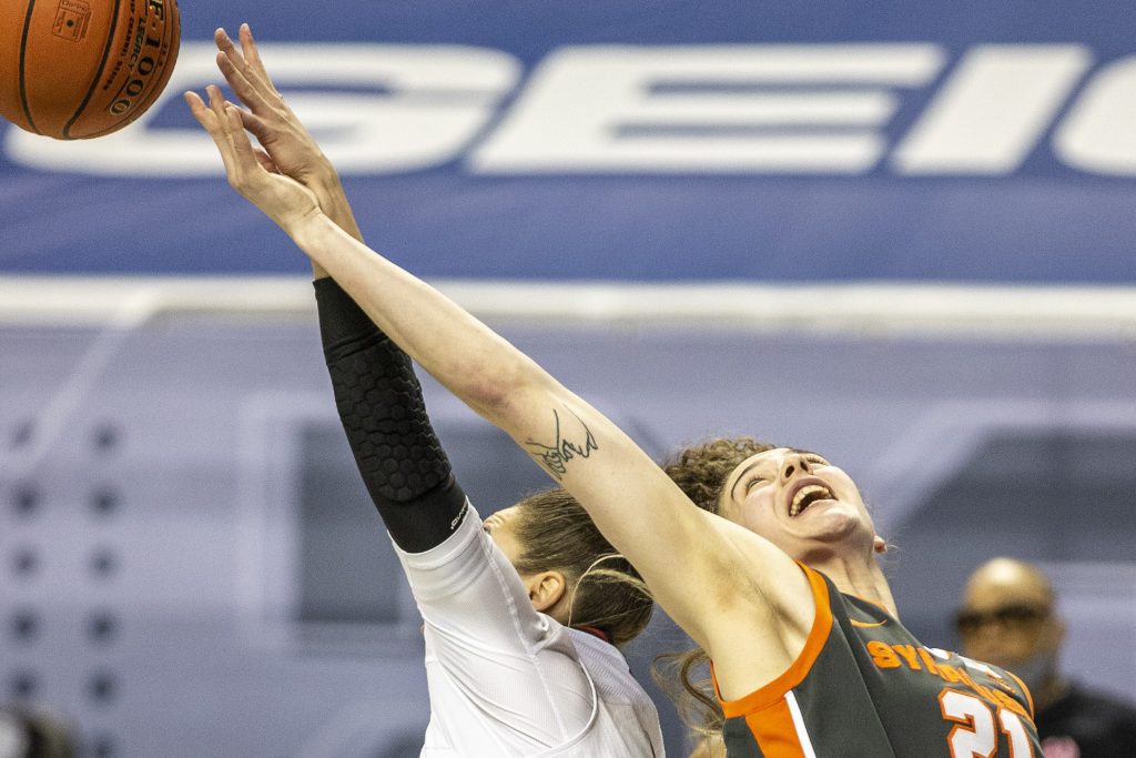 Syracuse's Emily Engstler reaches for a rebound during an NCAA college basketball game with Louisville in the Atlantic Coast Conference tournament at the Greensboro Coliseum in Greensboro, N.C., on Saturday, March 6, 2021.