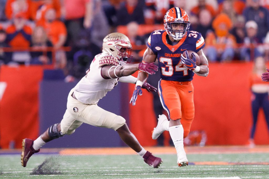 Sean Tucker outruns a Florida State defender in a game on Oct. 14, 2022 in the JMA Wireless Dome.