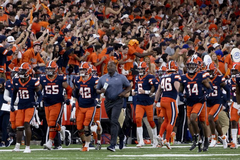 Syracuse head coach Dino Babers leads the SU Football team onto the field vs. NC State.