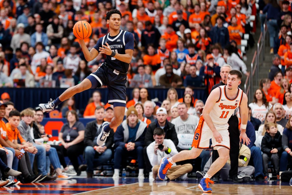 Wayne Bristol Jr. #31 of the Georgetown Hoyas looks to pass the ball against Joseph Girard III #11 of the Syracuse Orange at JMA Wireless Dome on December 10, 2022