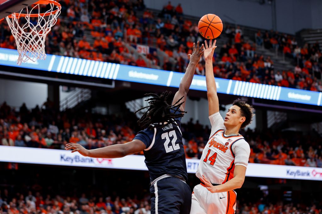 Jesse Edwards #14 of the Syracuse Orange attempts a shot over Bradley Ezewiro #22 of the Georgetown Hoyas at JMA Wireless Dome on December 10, 2022 in Syracuse, New York.