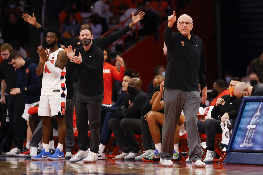 Syracuse coach Jim Boeheim points and calls out a play as the Orange bench celebrates.