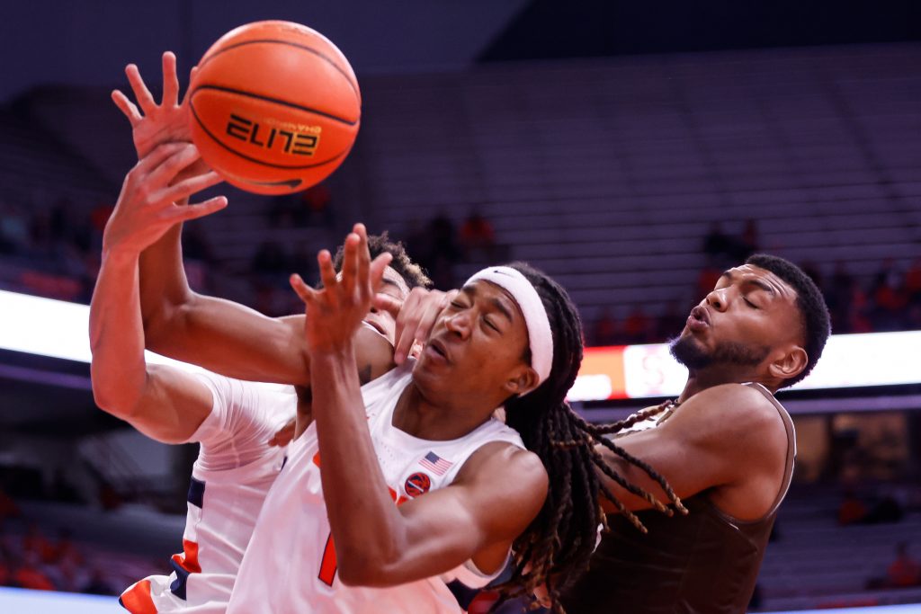 Syracuse's Maliq Brown (1) tries to gain possession of the ball with pressure in the paint from Lehigh's Jakob Alamudun (right).
