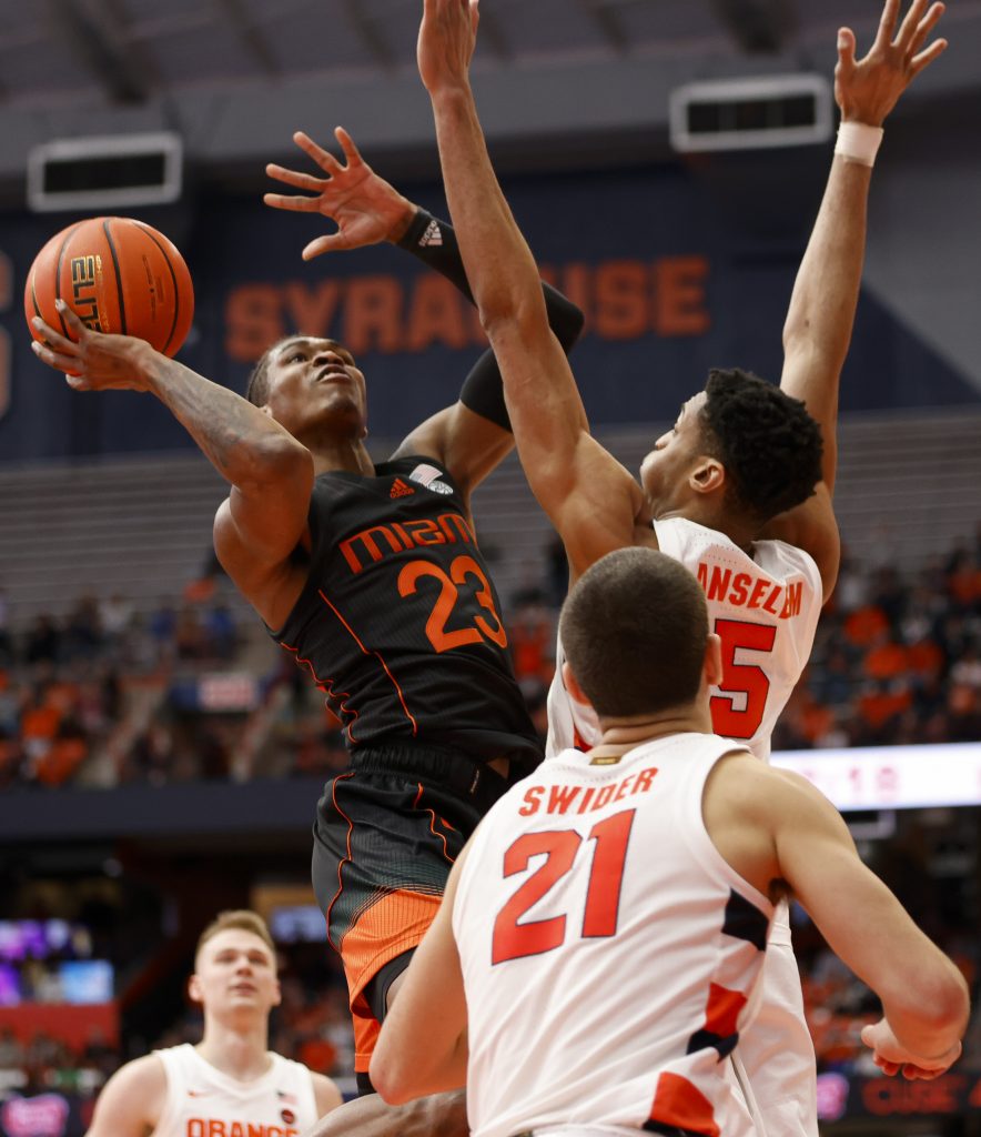 Miami's Kameron McGusty (23) goes up for a shot against Syracuse's Frank Anselem (5).