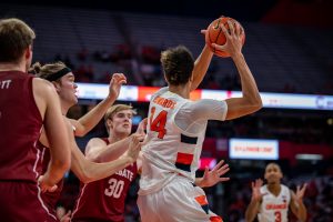 Syracuse's Jesse Edwards (14) is swarmed by Colgate Raiders' defenders on November 15th, 2022.