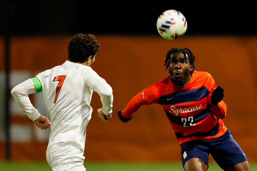 SYRACUSE, NY - NOVEMBER 9: Olu Oyegunle #22 of Syracuse Orange looks at the ball against Leo Afonso #7 of Virginia Cavaliers during the ACC Semifinal at SU Soccer Stadium on November 9, 2022 in Syracuse, New York. (Photo by Isaiah Vazquez/The Newshouse)