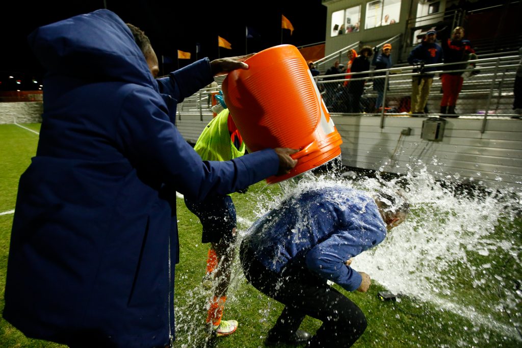 SYRACUSE, NY - NOVEMBER 9: The Syracuse Orange dump water on Head coach Ian McIntyre of Syracuse Orange during the ACC Semifinal at SU Soccer Stadium on November 9, 2022 in Syracuse, New York. (Photo by Isaiah Vazquez/The Newshouse)