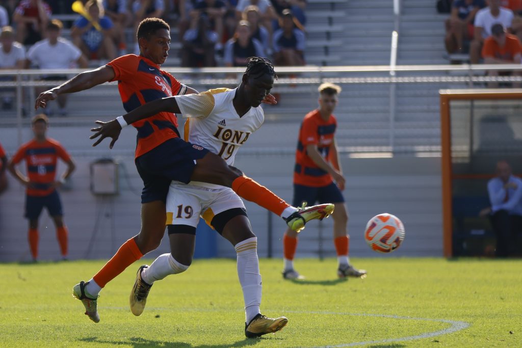Syracuse's Amferny Sinclair (5) gets a foot to a loose ball before Iona's Aly Camara (19) can.