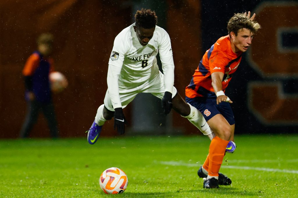 Wake Forrest's Babacar Niang (8) goes airborne near Syracuse's Lorenzo Boselli (11) challenging for the ball on Friday.