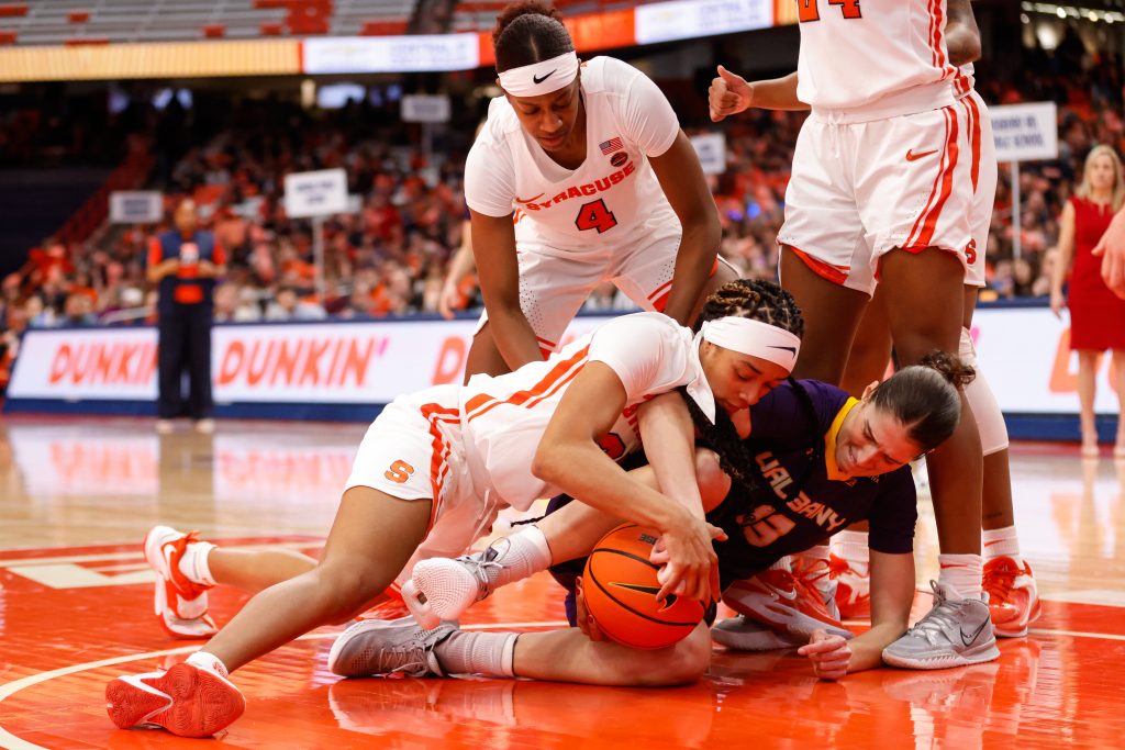 Syracuse's Alaina Rice (25) and Albany's Morgan Haney (15) fight for a loose ball during a women's basketball game on Tuesday, December 20, 2022, at JMA Wireless Dome.