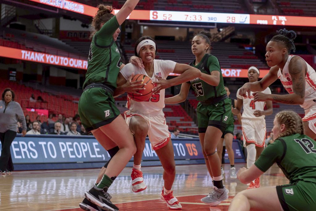 Alaina Rice, 25, pushes through Binghamton defense to attempt a basket Monday night during their match.
