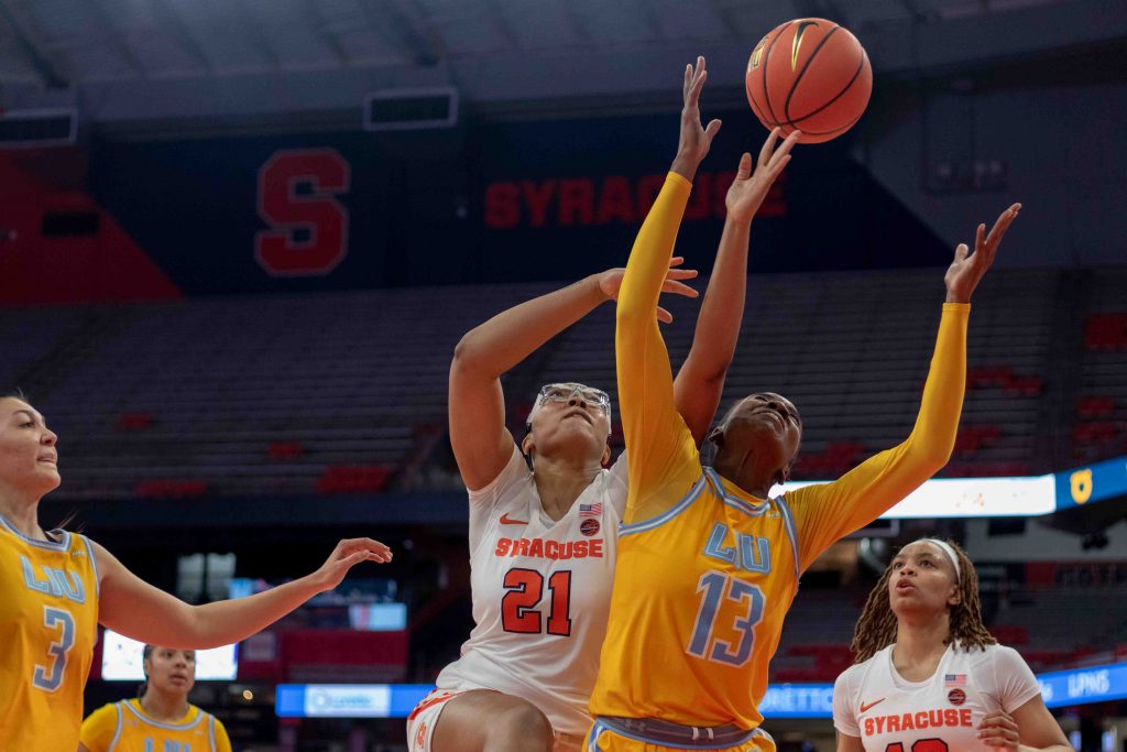 Saniaa Wilson (21) fights LIU (13) Iris Mbulito for a rebound posession Thursday night.