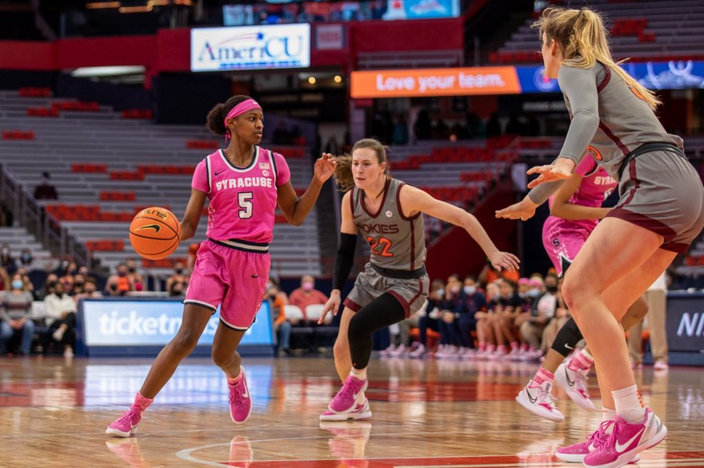 Syracuse's Teisha Hyman (5) moves around the court as Virginia Tech's Cayla King (22) follows closely behind.