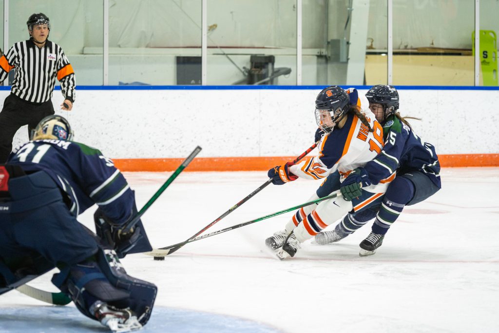 Syracuse's Tatum White dekes around Mercyhurst's Sydney Pederson for a shot on net.