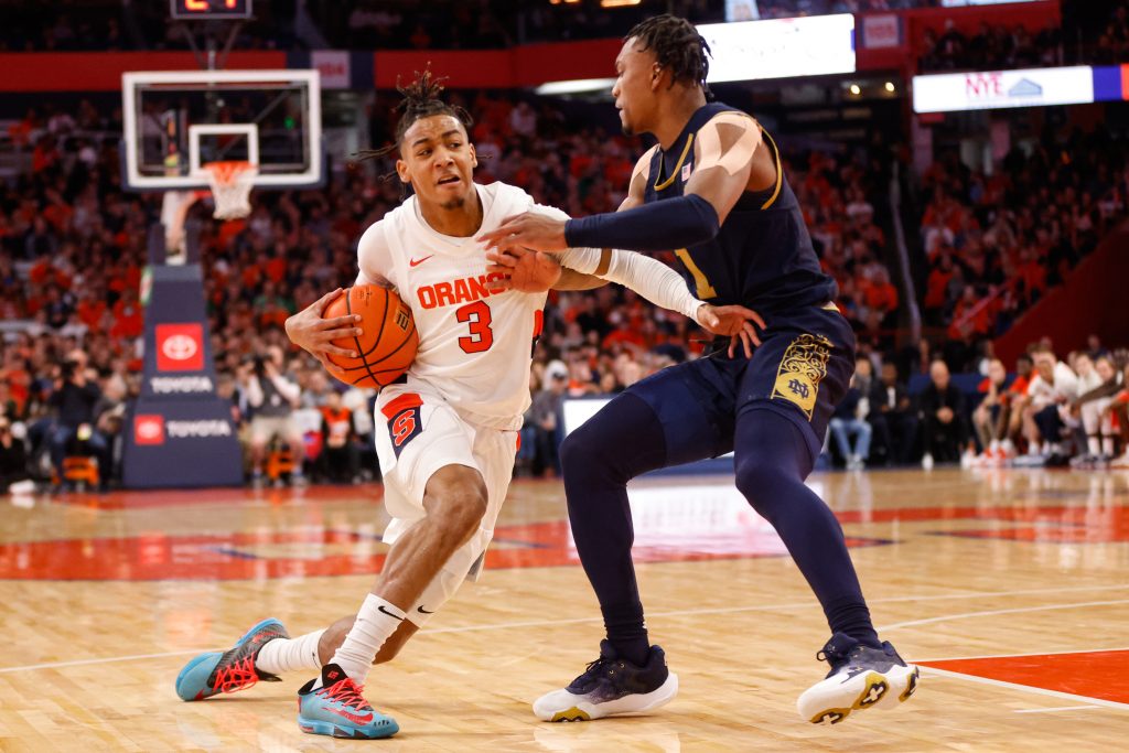 Syracuse's Judah Mintz (3) attempts to run by Notre Dame's JJ Starling (1) during an ACC basketball game Saturday at JMA Wireless Dome.