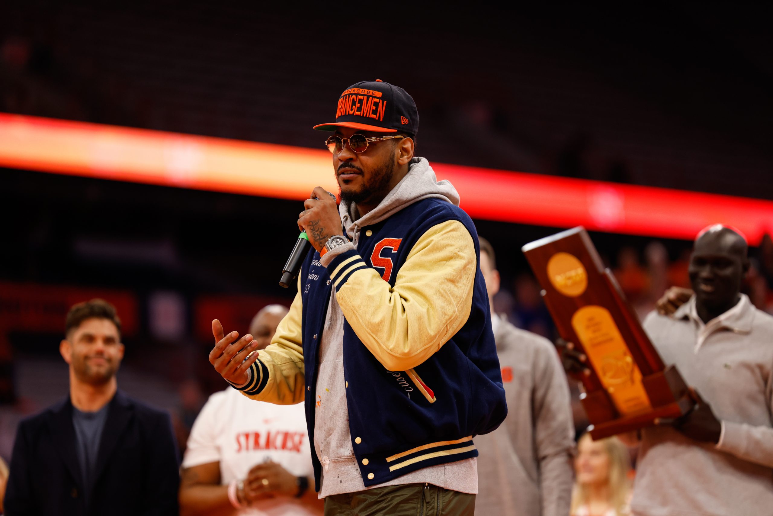 Carmelo Anthony speaks while surrouded by fellow members of the 2003 NCAA Championship Team during an ACC men's basketball game against Wake Forest on Saturday, March 4, 2023, at JMA Wireless Dome.