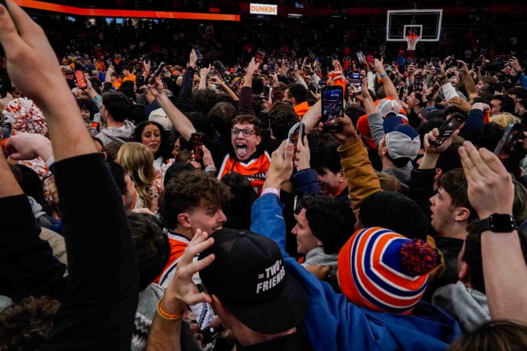 Syracuse students storm the JMA Wireless Dome court after a 62-60 upset win over Tennessee on Tuesday, December 2.