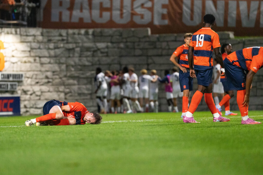 Defensemen Tim Brdaric(4) injured as Penn State celebrate the equalizing goal during Syracuse Men’s Soccer game against Penn State on August 28, 2025, at SU Soccer Stadium in Syracuse, New York