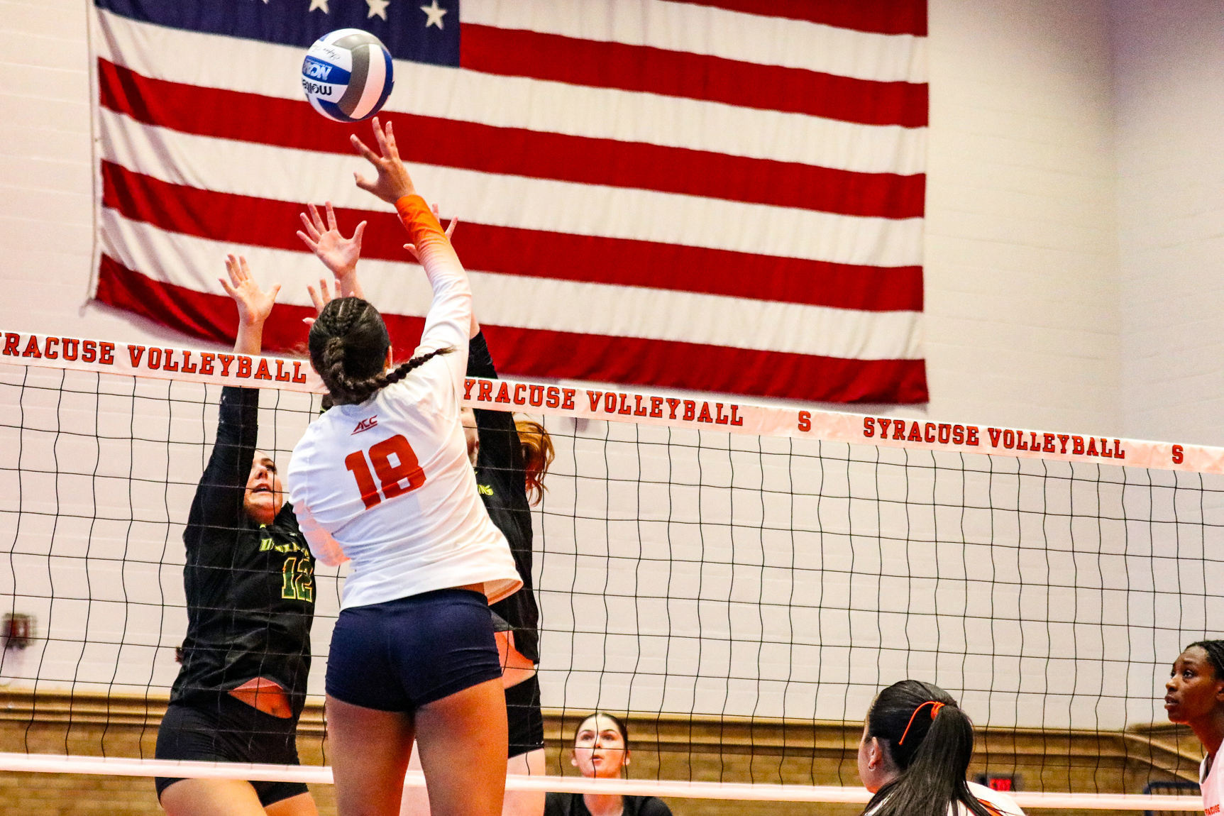 Gabreilla McLaughlin (18) spikes against members of the Le Moyne women's volleyball team during their match on Saturday.