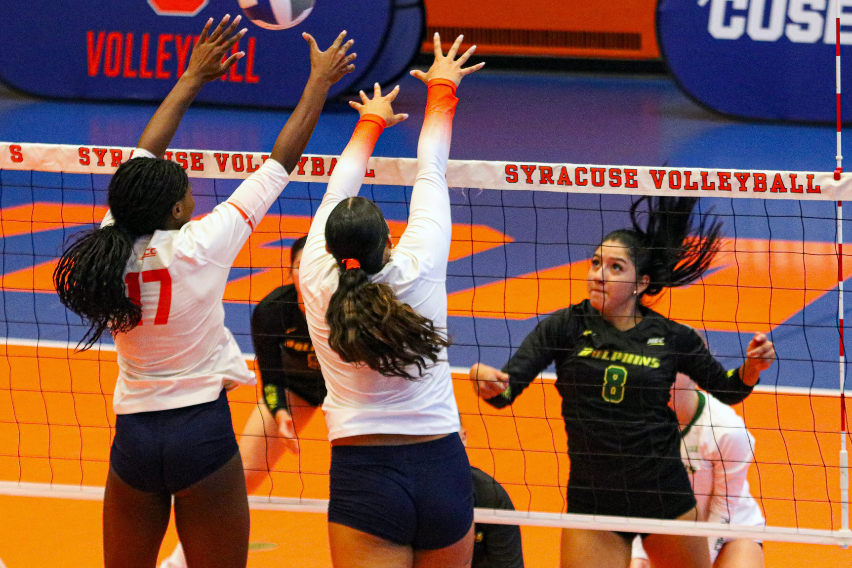 Oreva Evivie (17) blocks with her teammate in SU's match against Le Moyne on Sunday.