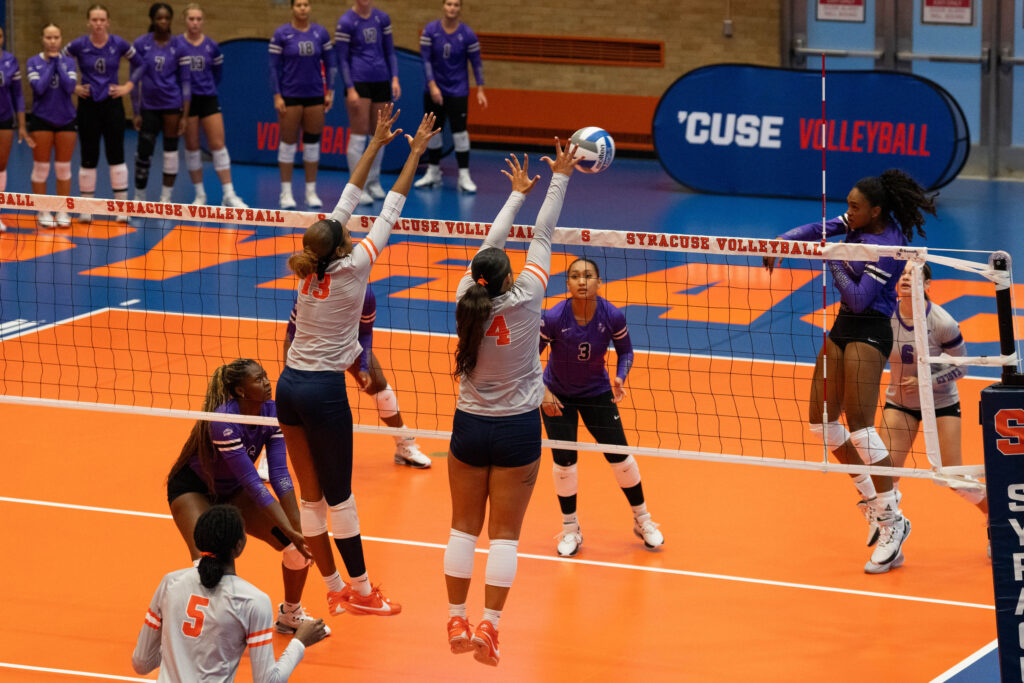 Outside hitter Zharia Harris-Waddy (13) and Setter Tehya Maeva (14) blocking during Syracuse Women’s Vollyball game against Niagara University on August 29, 2025, at SU Women's Building in Syracuse, New York.