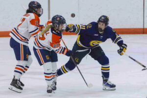 Syracuse University Women’s Ice Hockey player Haley Trudeau (17) and Quinnipiac Bobcats player Laurence Frenette (21) watch the puck in the air during their match on October 10, 2025, at home, the Tennity Ice Pavilion.