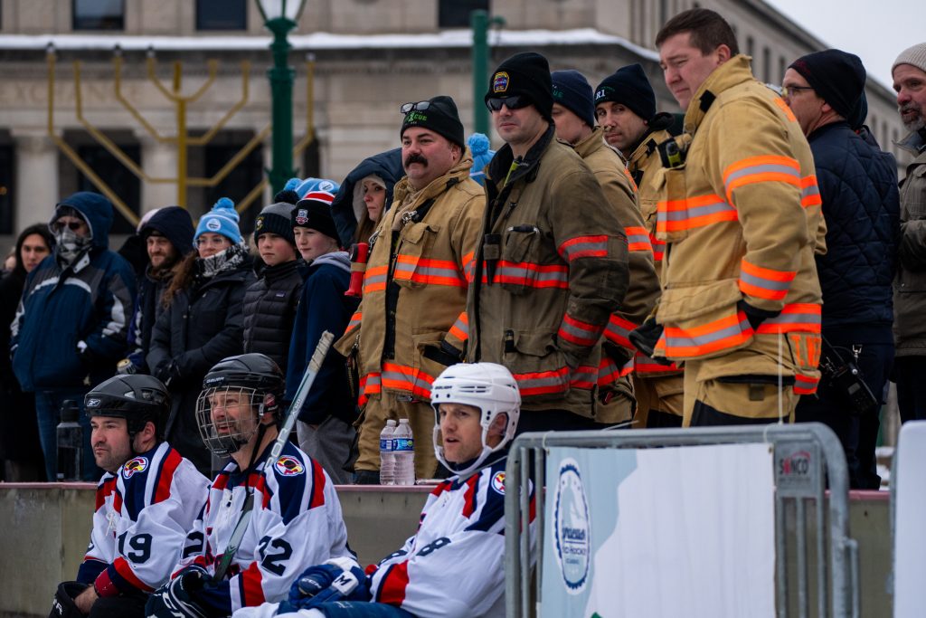 Syracuse firefighters support their team during the Pond Hockey Classic at Clinton Square in Syracuse on Jan. 25, 2025.