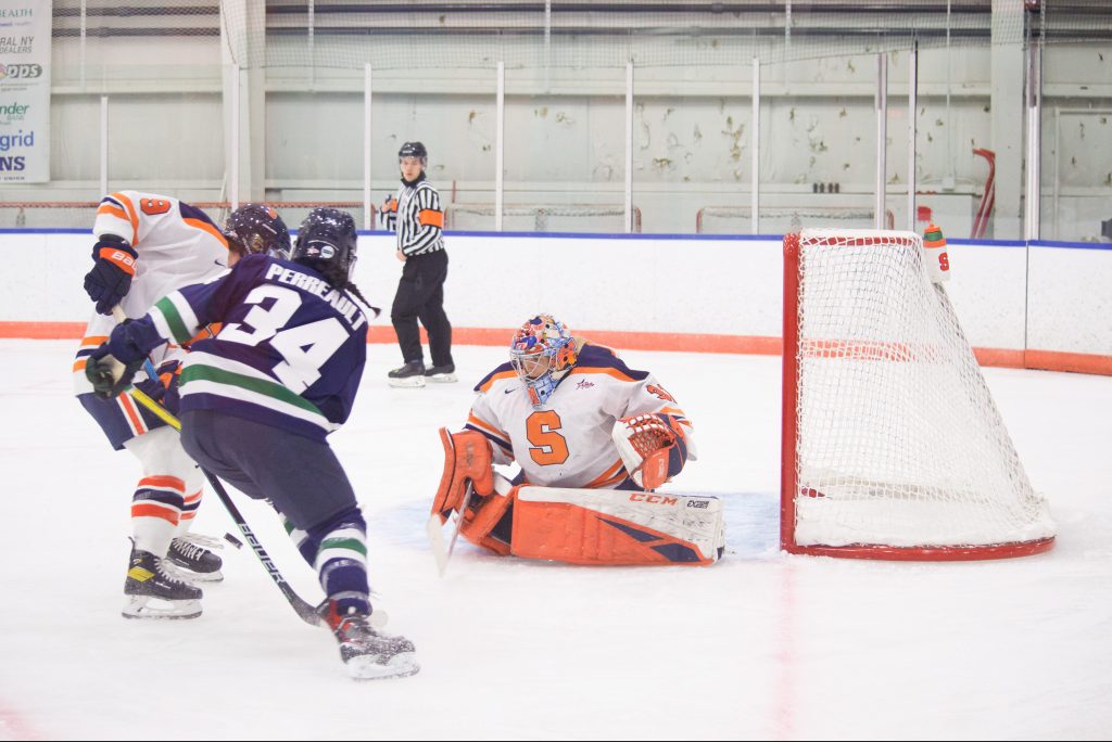 Allison Small keeps her eye on the puck as Mercyhurst's Liliane Perreault drives to the net.