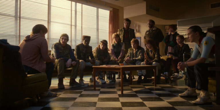 In Stranger Things Season 5, the main characters sit in a room of the radio station around a table to listen to the character of Will Byers.