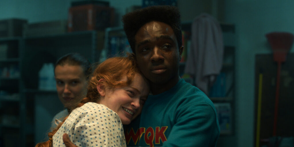 In Stranger Things Season 5 Max Mayfield and Lucas Sinclair share a hug in the hospital basement.