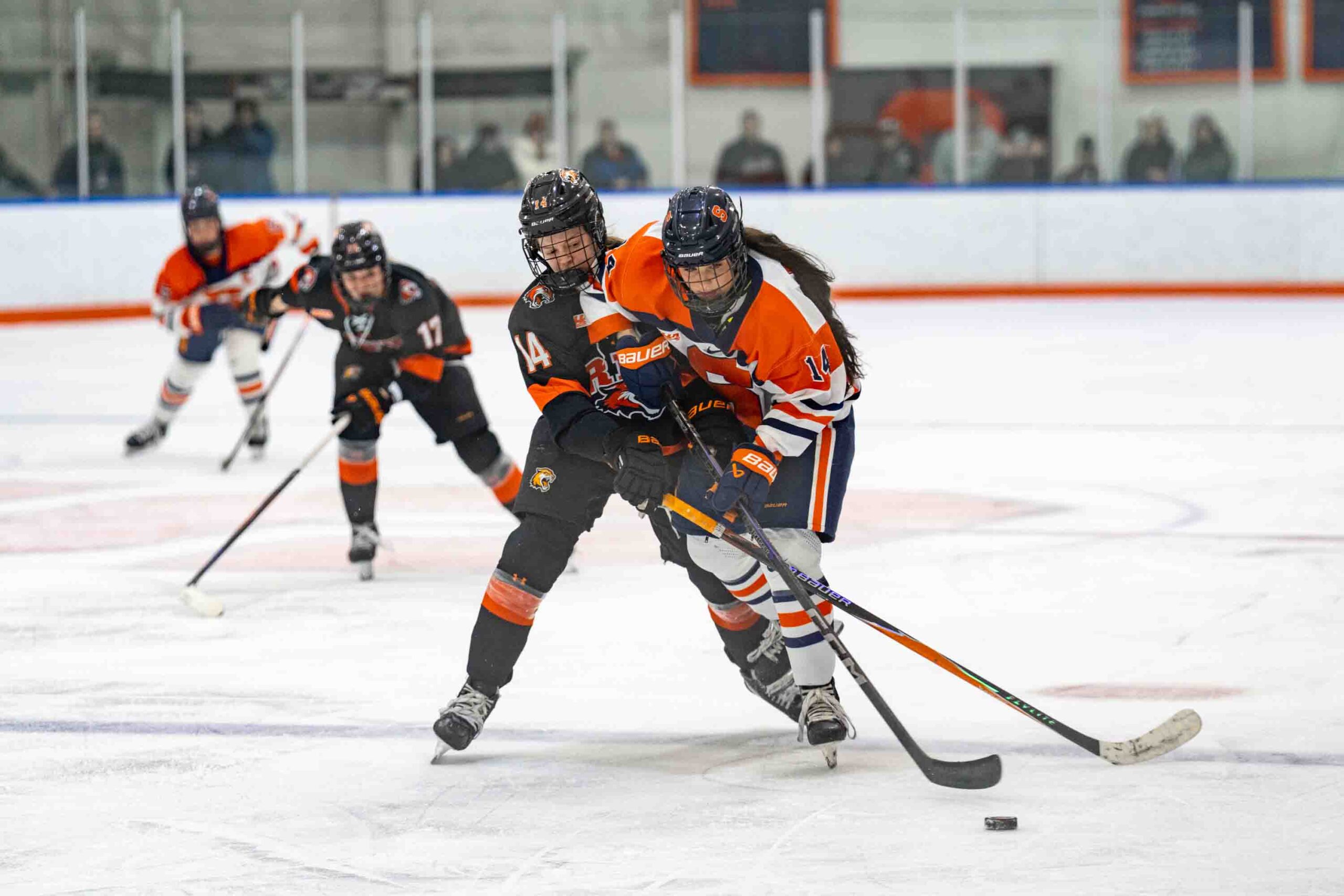 Forward Jordan Blouin (14) fighting for ther puck during Syracuse Women’s Hockey game against RIT University on February 6, 2026, at Tennity Ice Pavilion in Syracuse, New York.