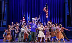 Cast of The Music Man national tour pose after big dance number.