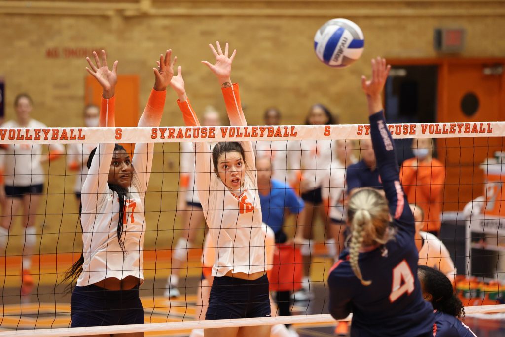 Syracuse's Naomi Franco and Abby Casiano attempt a block against University of Connecticut's Caylee Parker during the first set on August 27, 2021.