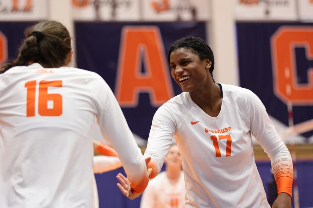 Syracuse's Naomi Franco (right) reacts after picking up Abby Casiano (left) during a volleyball match against University of Connecticut at the Women's Building on August 27, 2021.