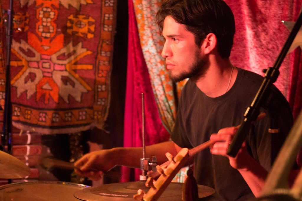 Stefan Castro-Del-Bosque looks ahead while playing the drums.