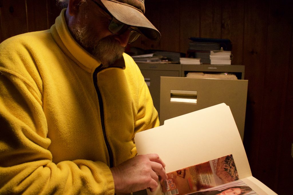 Block flips through his autograph books.