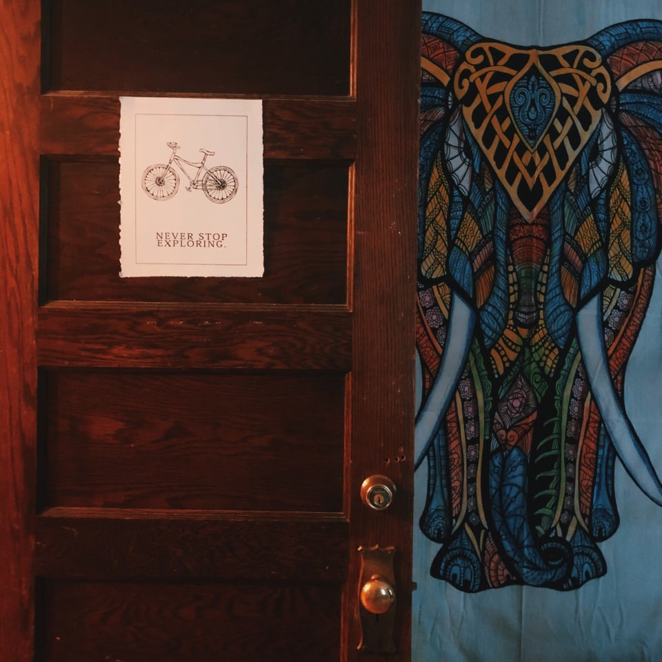 A sign printed by his friend and classmate Molly Coletta hangs on Pershing’s door: Never Stop Exploring