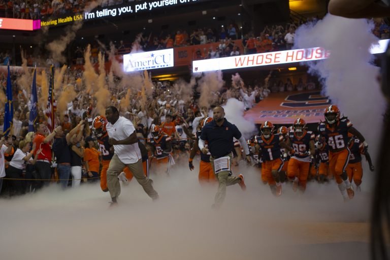 Dino Babers leads the Syracuse football team out to the stadium at Syracuse University's Carrier Dome on Sept. 14, 2019.