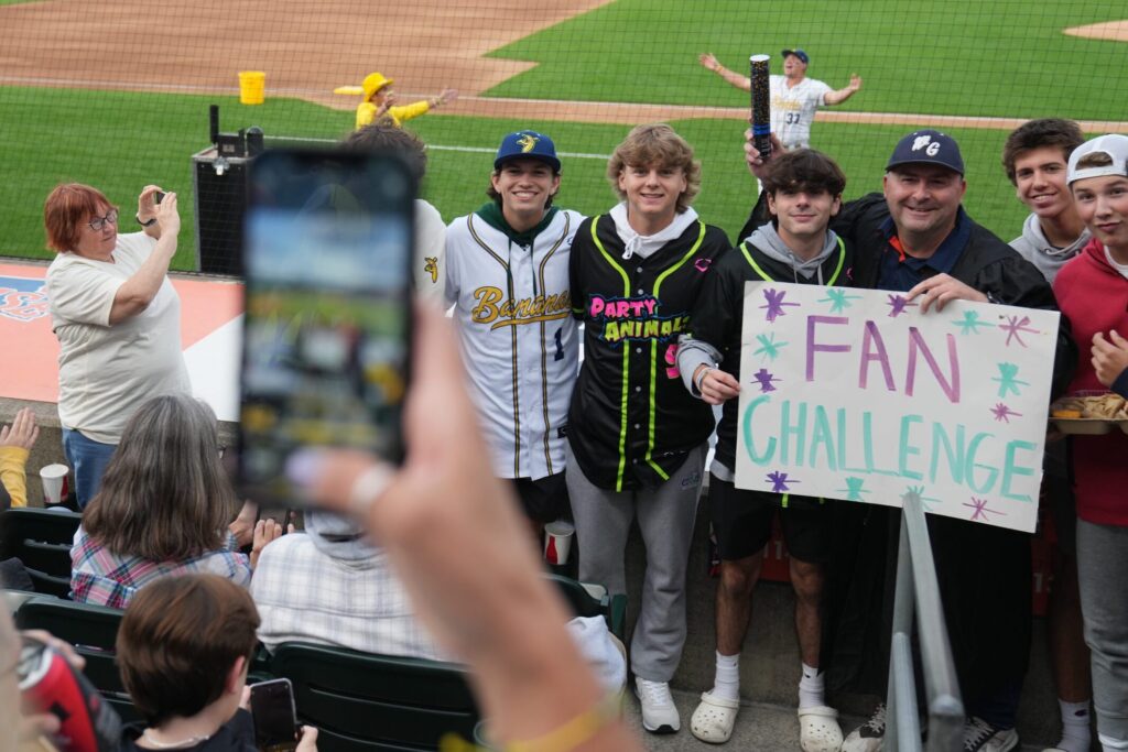 SU Professor Dave Meluni gets his photo taken with the team he coaches, at the Savannah Banana’s baseball game held Thursday night, September 14, 2023 at NBT Stadium in Syracuse, NY. He was awarded the Fan of the game.