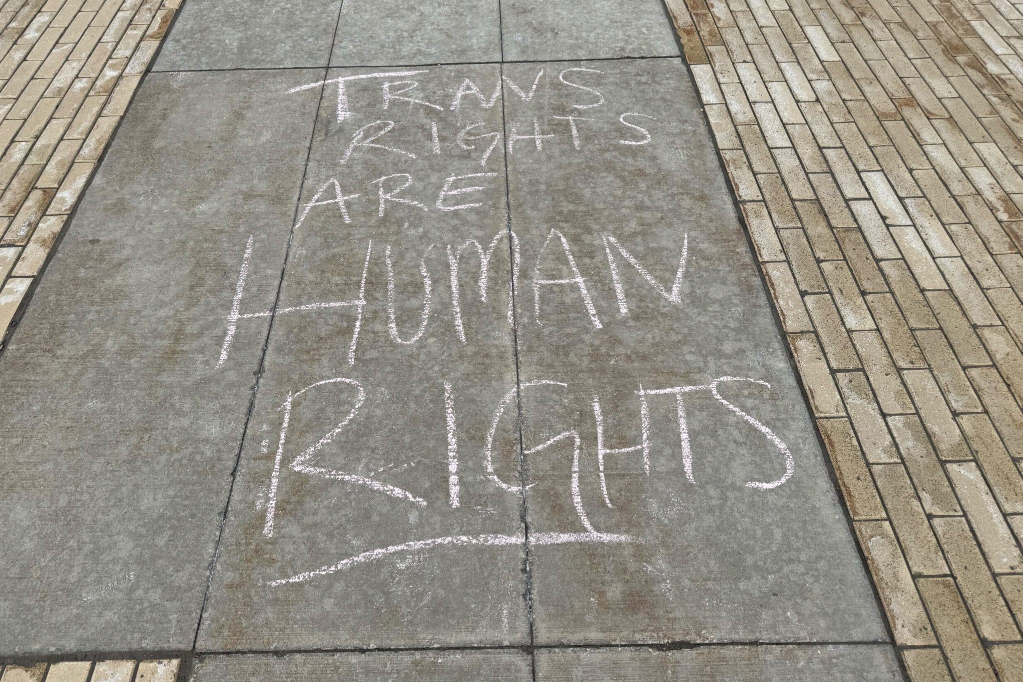 Sidewalk chalk on Trans Day of Visibility that reads "TRANS RIGHTS ARE HUMAN RIGHTS"