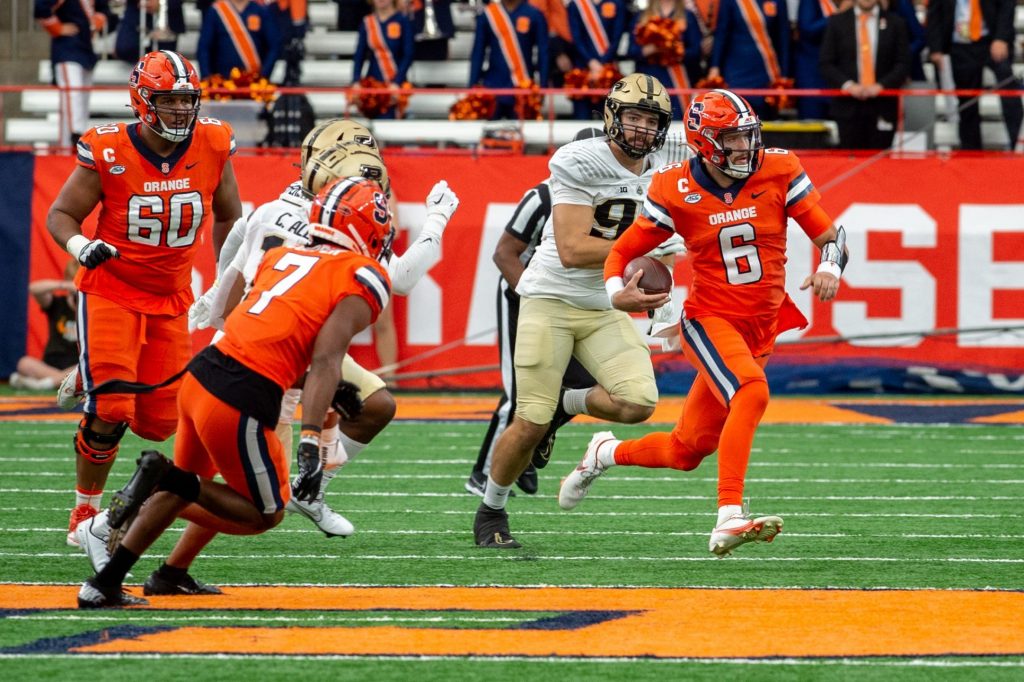 Syracuse quarterback Garrett Shrader runs past Purdue defenders at the JMA Wireless Dome on Sept. 17, 2022.