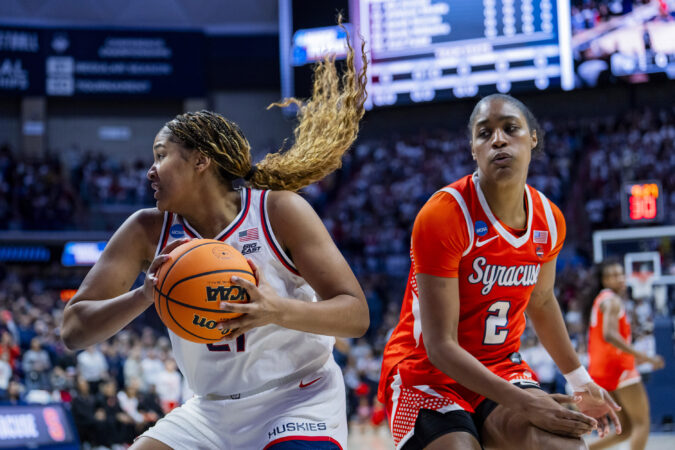 arah Strong #21 of the Connecticut Huskies gets the rebound against Journey Thompson #2 of the Syracuse Orange during the first half in the second round of the 2026 NCAA Women's Basketball Tournament at Harry A. Gampel Pavilion on March 23, 2026 in Storrs, Connecticut.