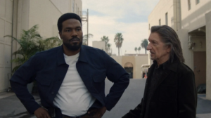 In 'Wonder Man' Yahya Abdul-Mateen II as Simon Williams and Ben Kingsley as Trevor Slatterly stand in a Hollywood back lot talking to one another.