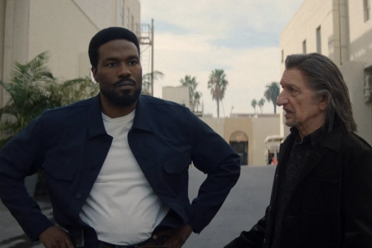In 'Wonder Man' Yahya Abdul-Mateen II as Simon Williams and Ben Kingsley as Trevor Slatterly stand in a Hollywood back lot talking to one another.